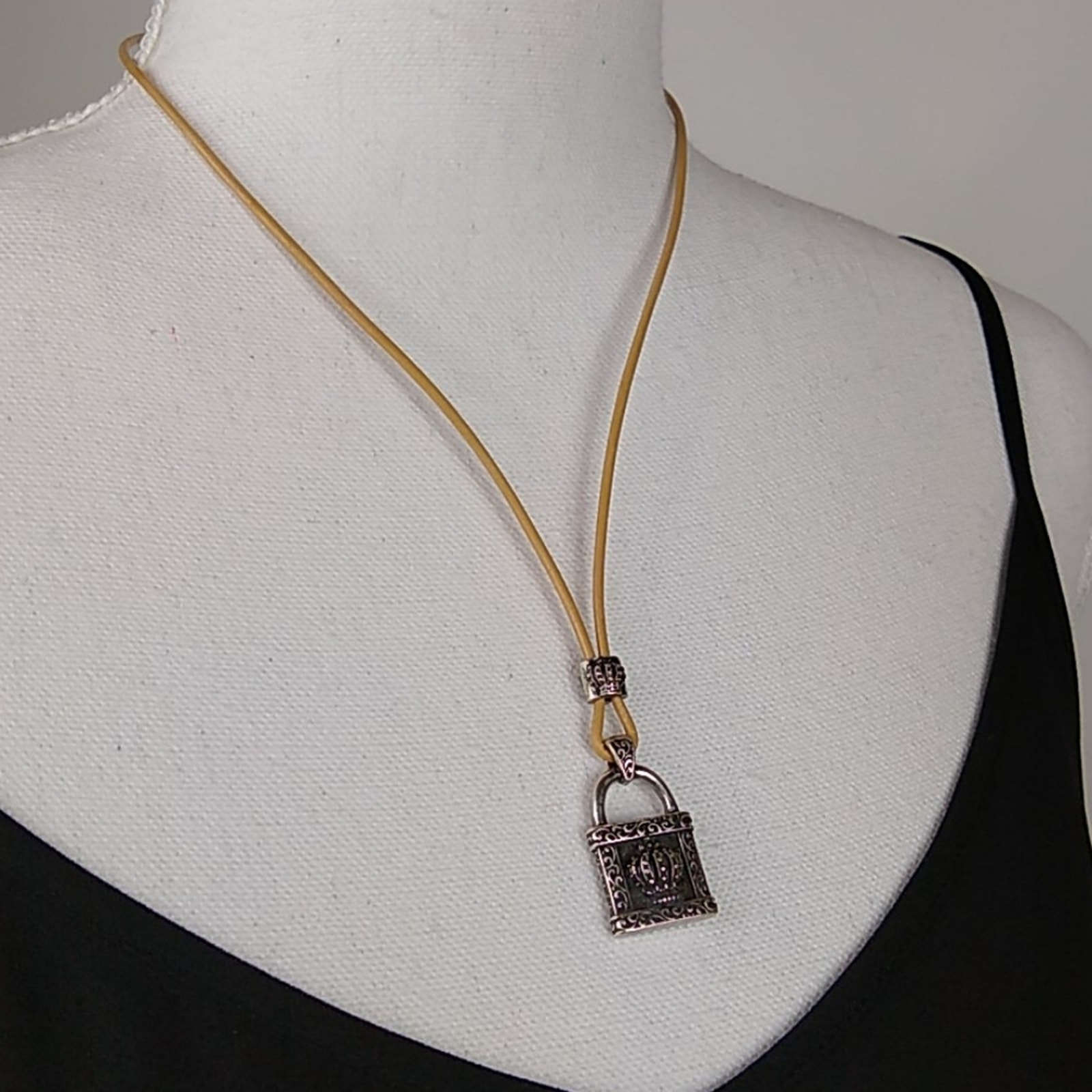 Stigma Silver Tone Crown Lock Pendant On Cord
